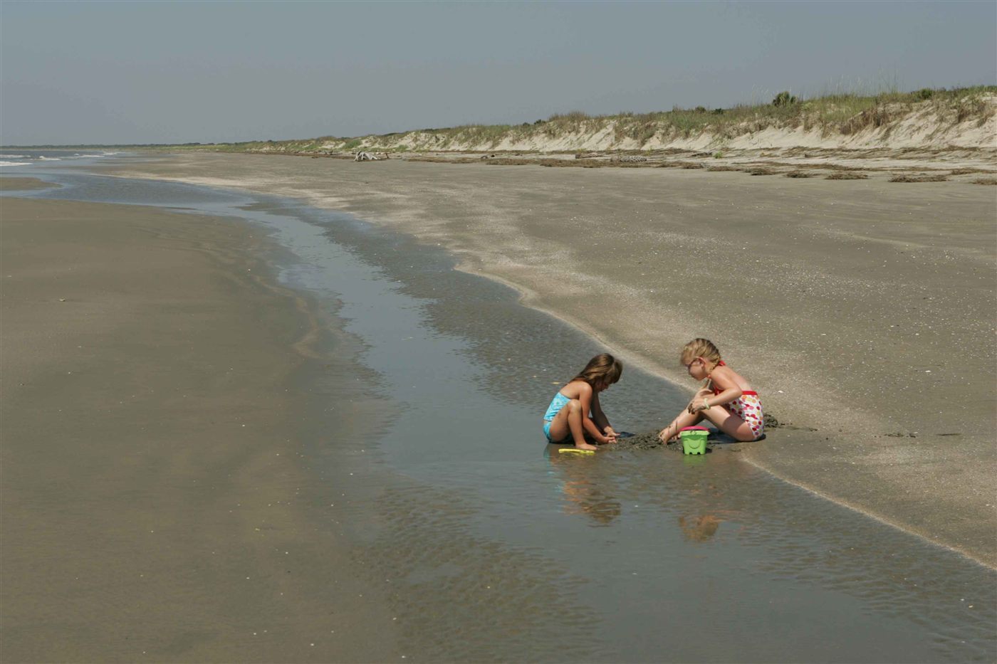 Children playing in beach sand for family activities near Naples Florida