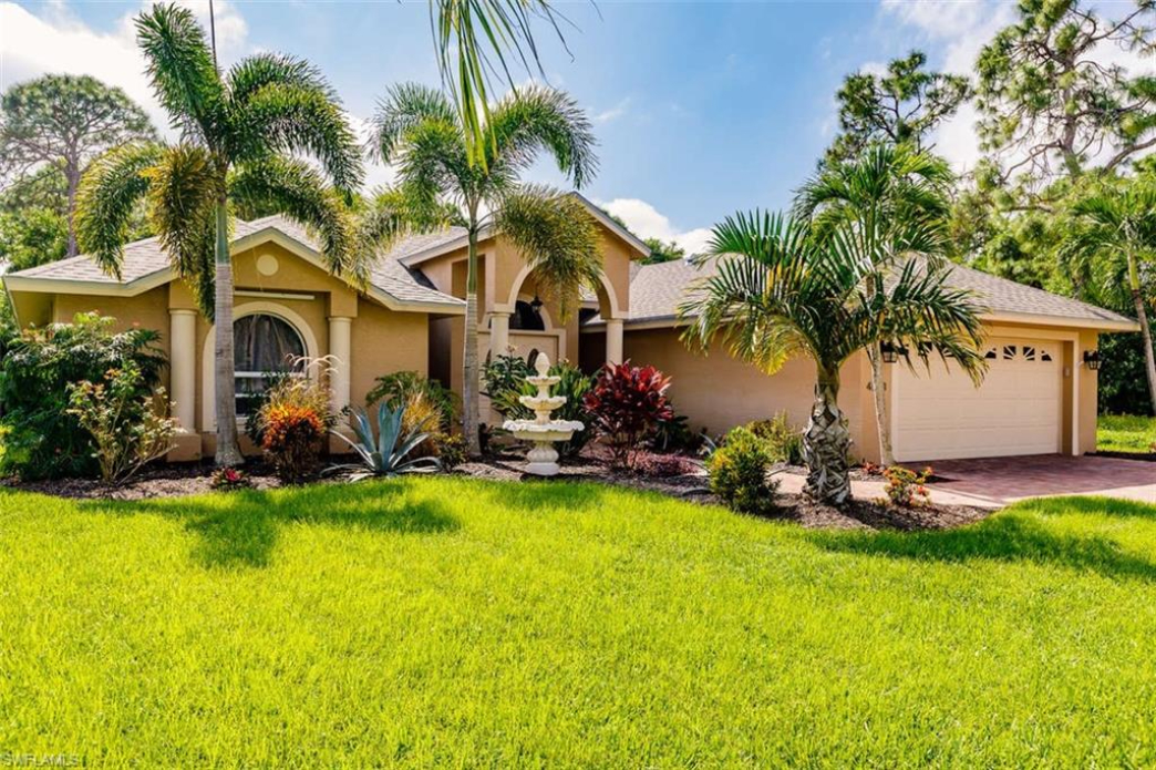 Front exterior of Tiki Paradise Retreat with palm landscaping